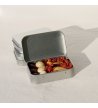 Biossom Snack Tin No. 02 – open tin with fruit, chocolate and nuts next to the product packaging