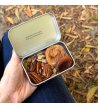 Biossom Snack Tin No. 03 – open tin with figs, apricots, pecans and pistachios beside the product packaging