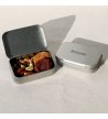 Biossom Snack Tin No. 03 – open tin with figs, apricots, pecans and pistachios beside the product packaging
